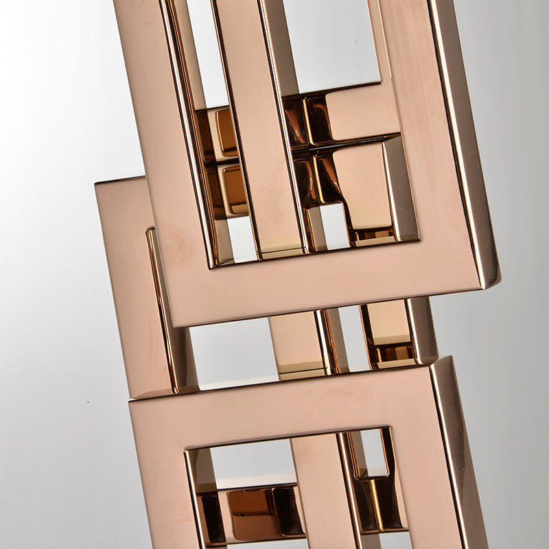 Close up detail of interlocking rose gold metal rectangular frames