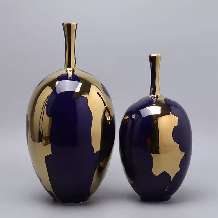 Two royal blue and gold ceramic vases side by side