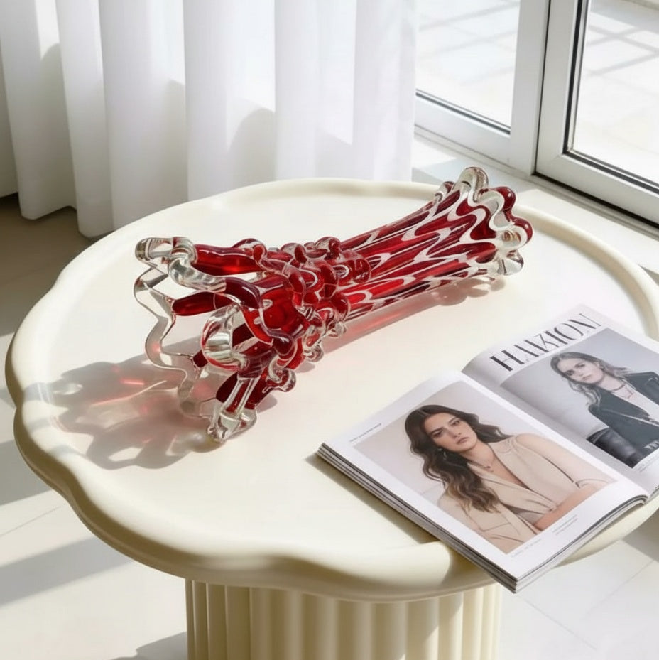 Top angle view of the ruby red art glass vase showing the wavy rim and hollow interior