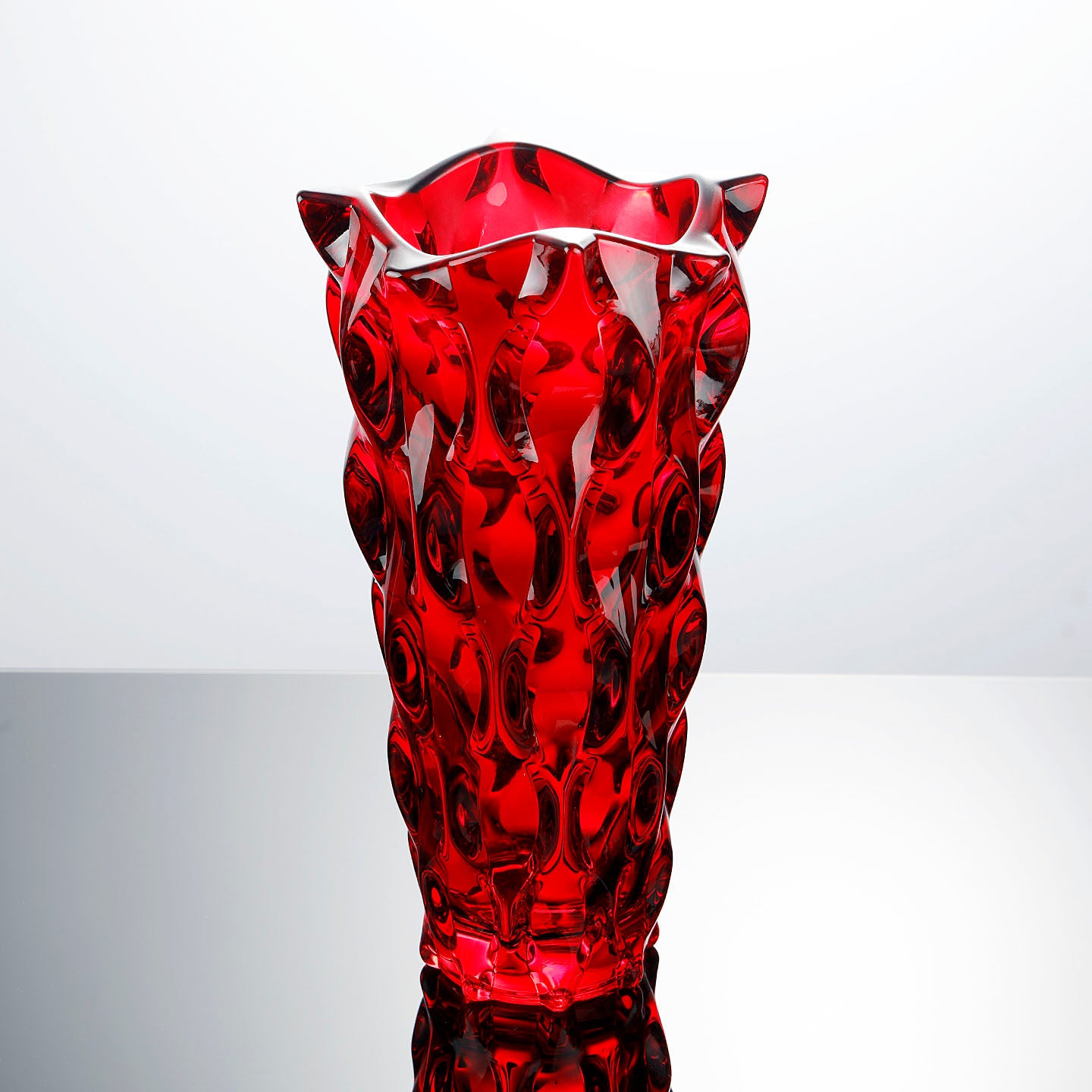 Front view of sculptural red glass vase