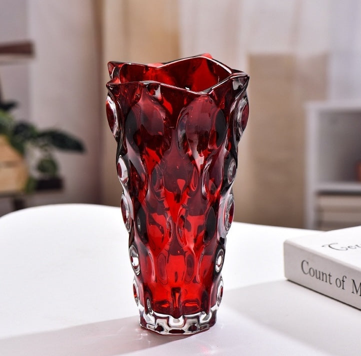 Front view of ruby red textured glass vase showing geometric pattern