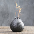 Round black ceramic vase with floral relief texture