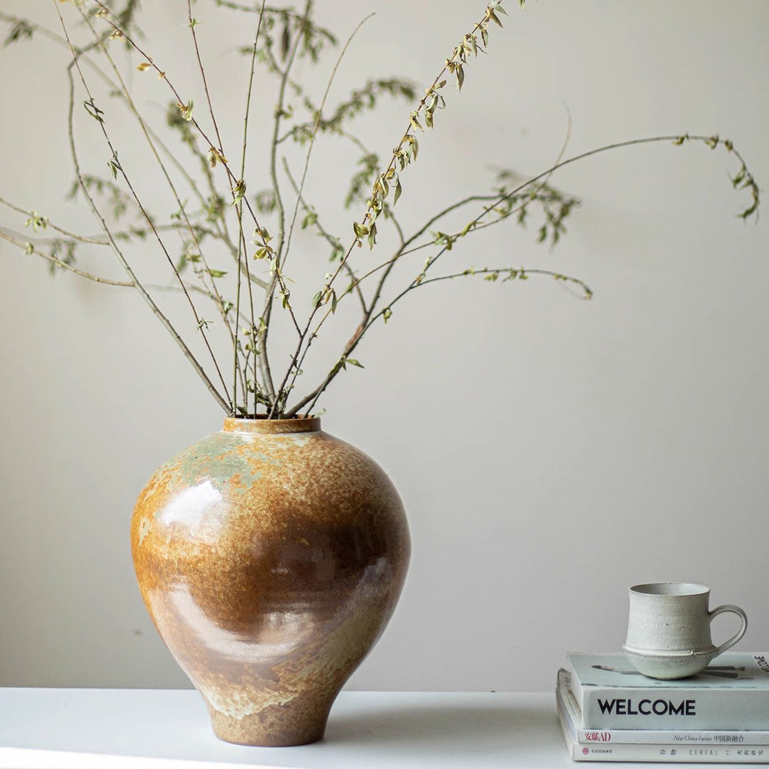 Rustic bronze glazed ceramic vase with tall branches