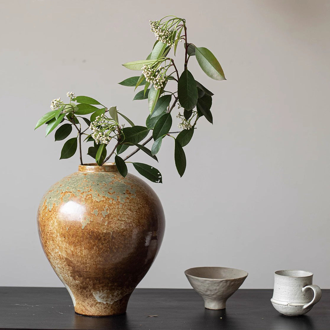 Detailed view of weathered ceramic finish on bulbous vase