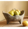 Close up of hand carved wood bowl with organic texture holding pears