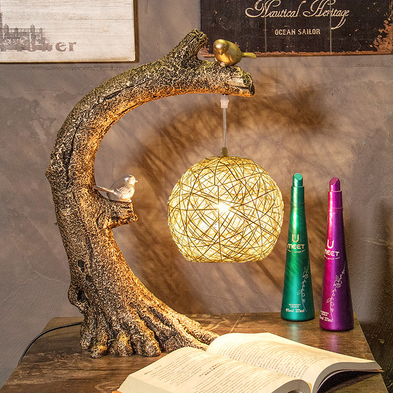 Context shot of lamp on wooden table with books