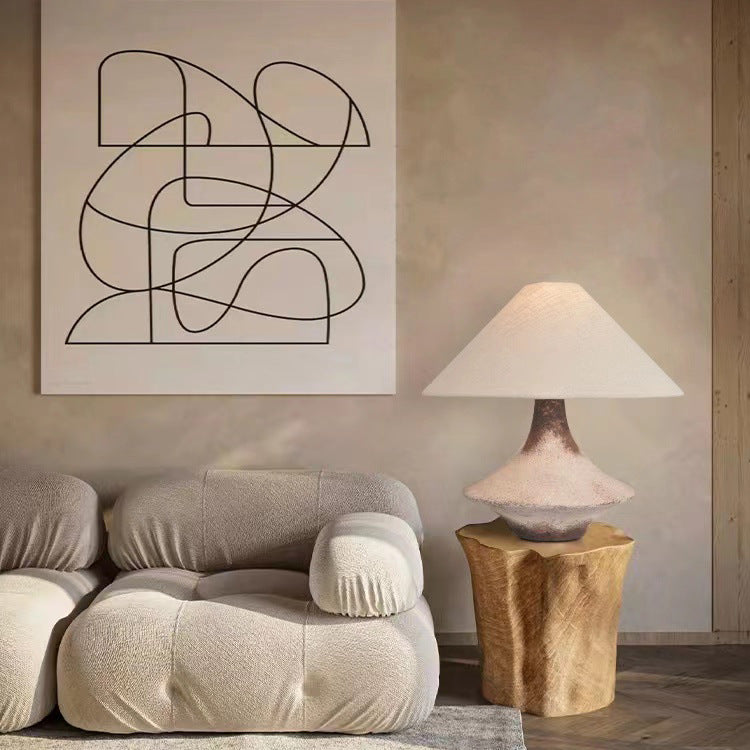 Rustic textured ceramic table lamp on wooden side table