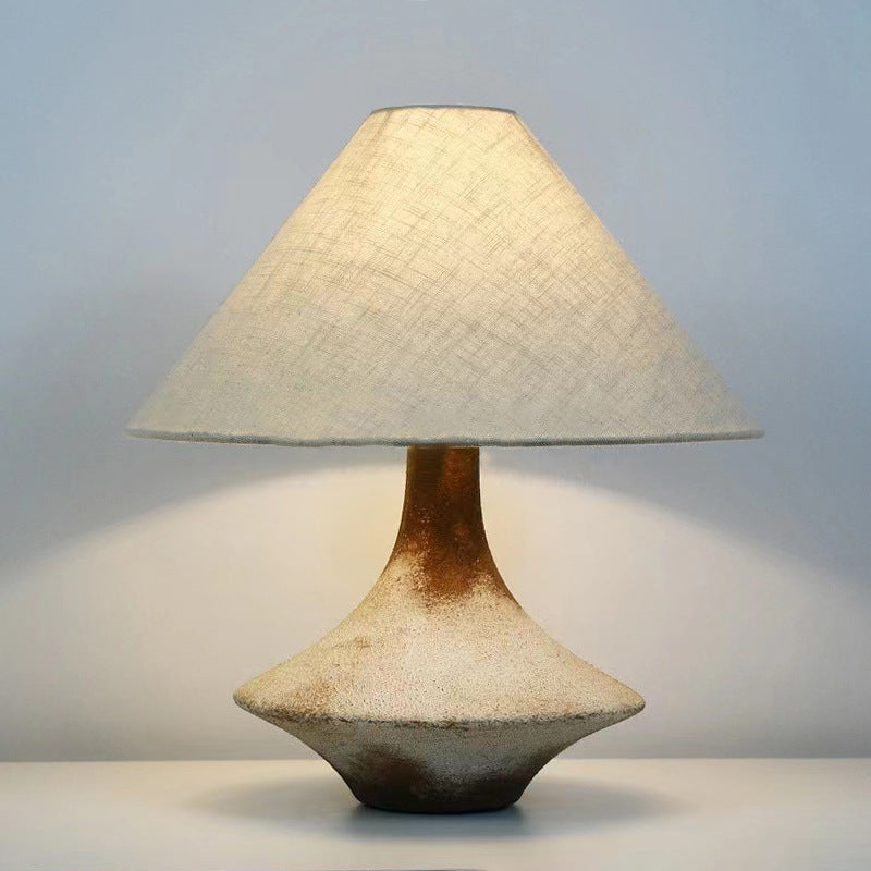 Illuminated rustic ceramic lamp showing textured base details