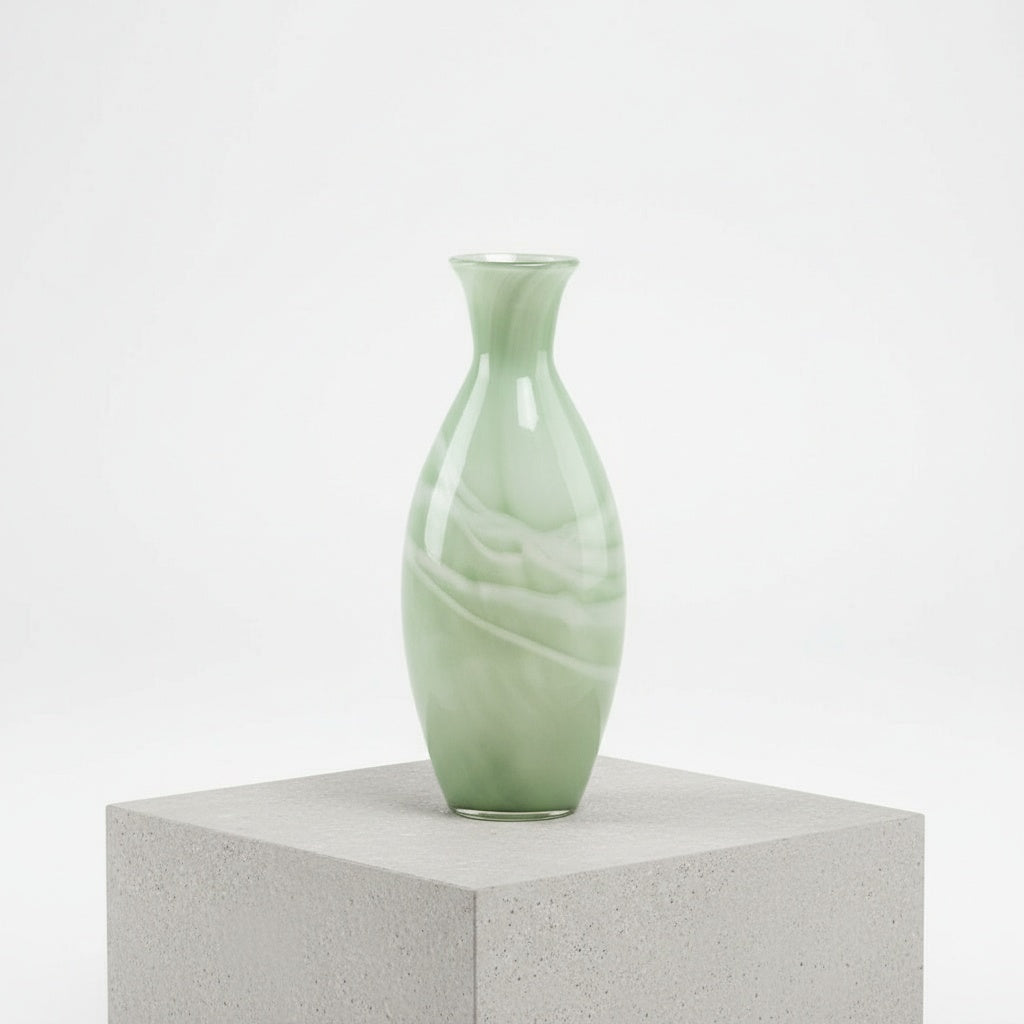 Studio shot of tall sage green marbled glass vase against white background