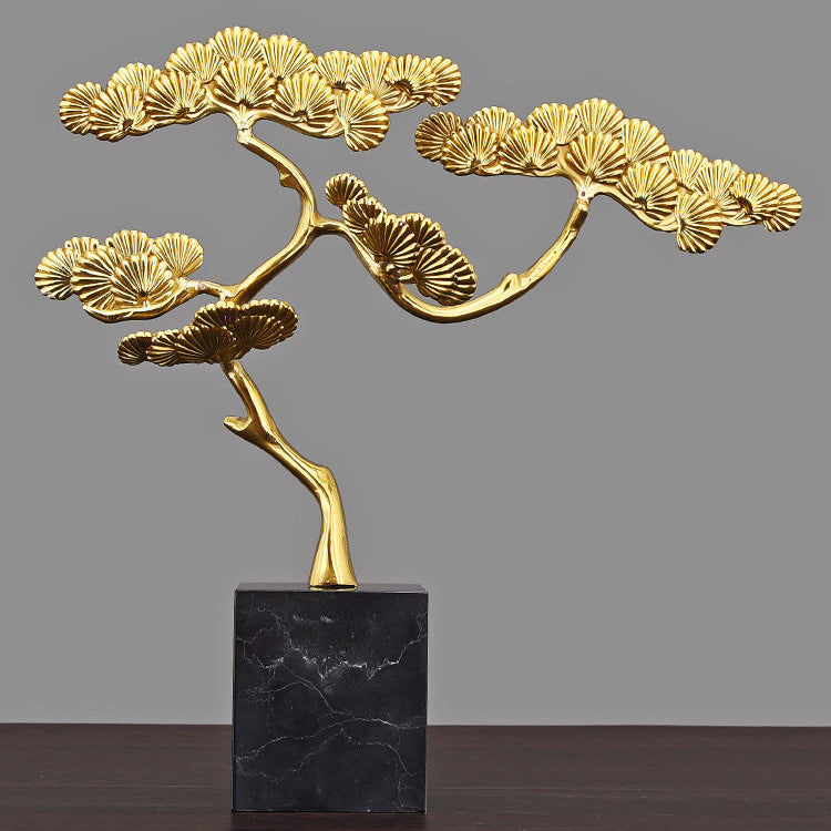 Handcrafted brass pine tree sculpture on a solid black marble base, front view