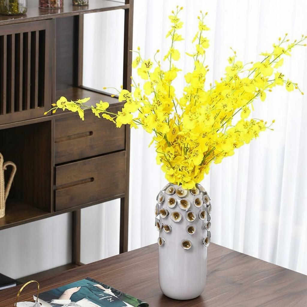 Sculptural Ceramic Cylindrical Vase styled with yellow flowers on a wooden table