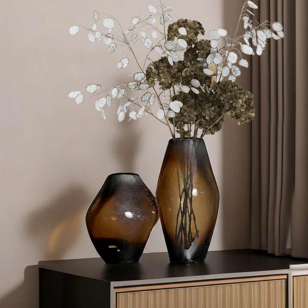 Large and medium organic glass vases styled on sideboard
