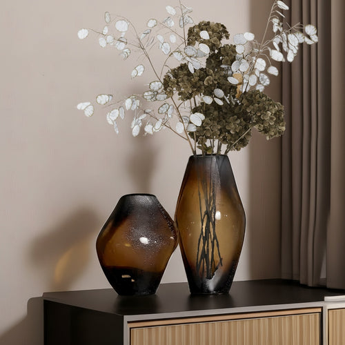 Tall and short amber seeded glass vases styled on console table with dried flowers