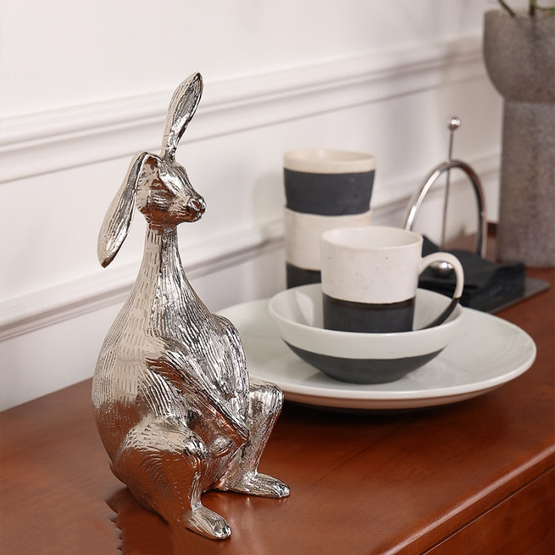 Lifestyle shot of aluminum hare sculpture on console table