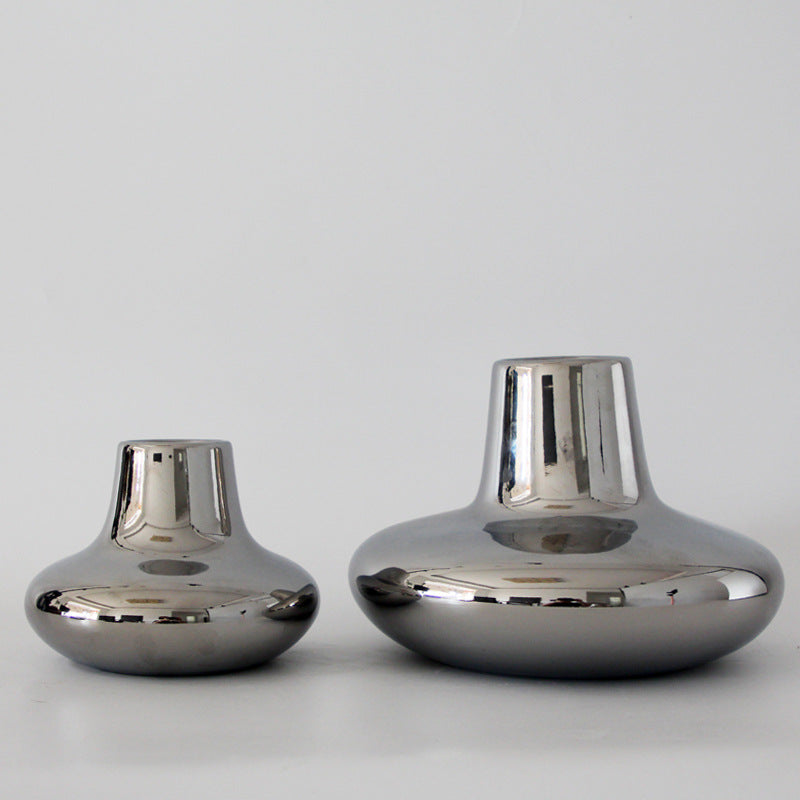 Comparison of large and small silver chrome vases
