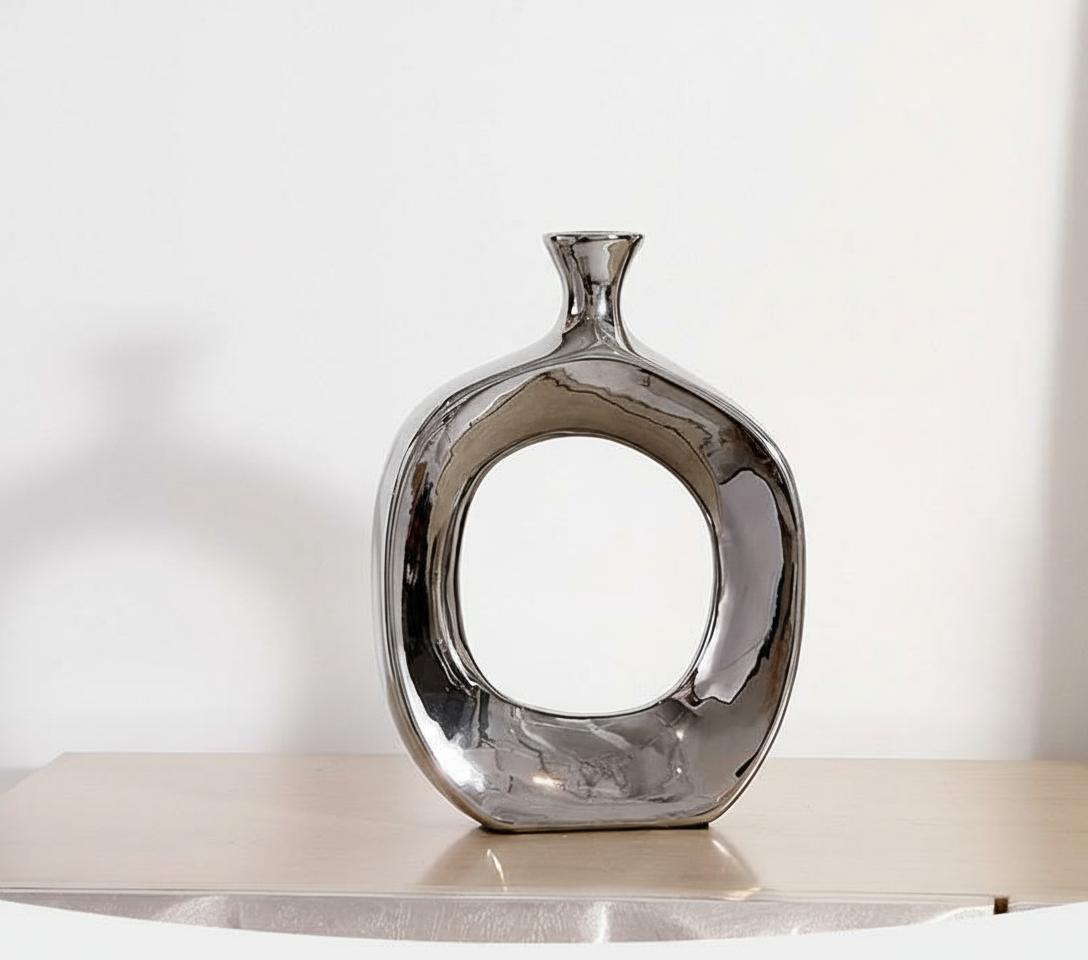 Lifestyle shot of silver chrome vase on wooden console