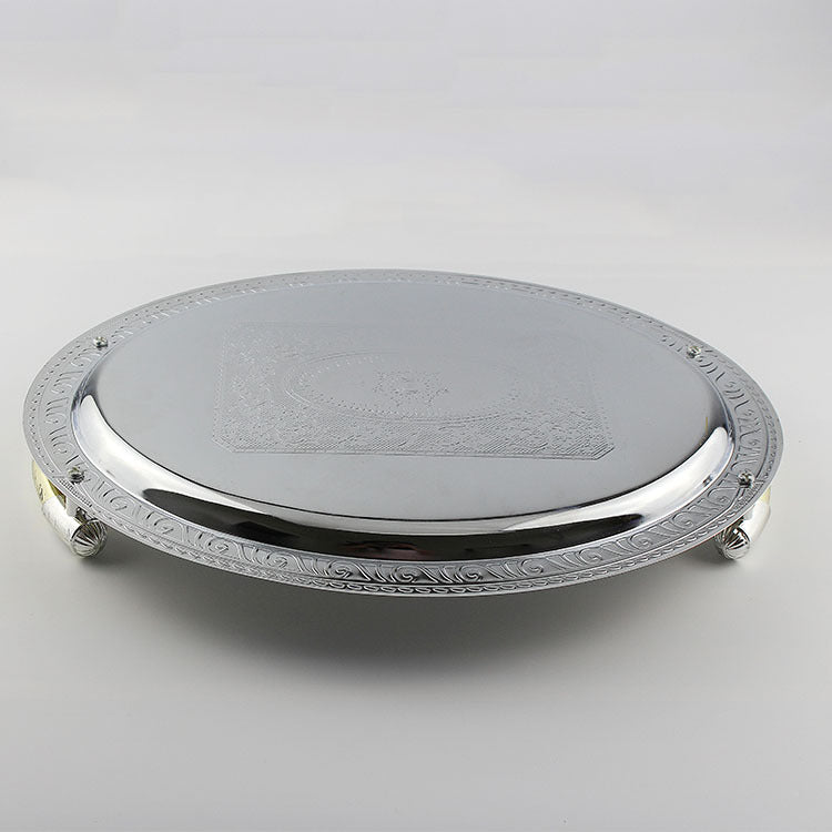 Underside view of silver metal tray showing polished finish and raised feet structure