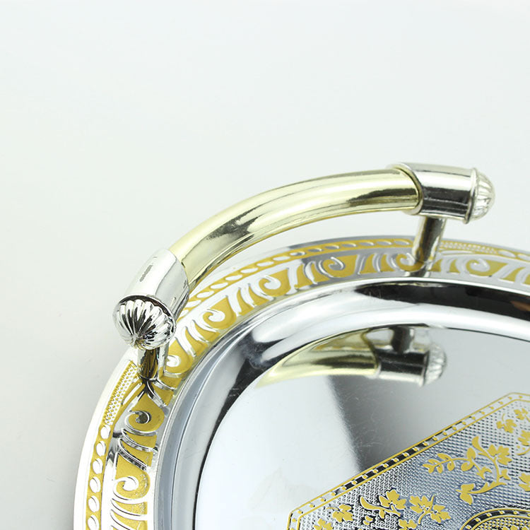 Close up detail of gold and silver handle attached to a decorative rim