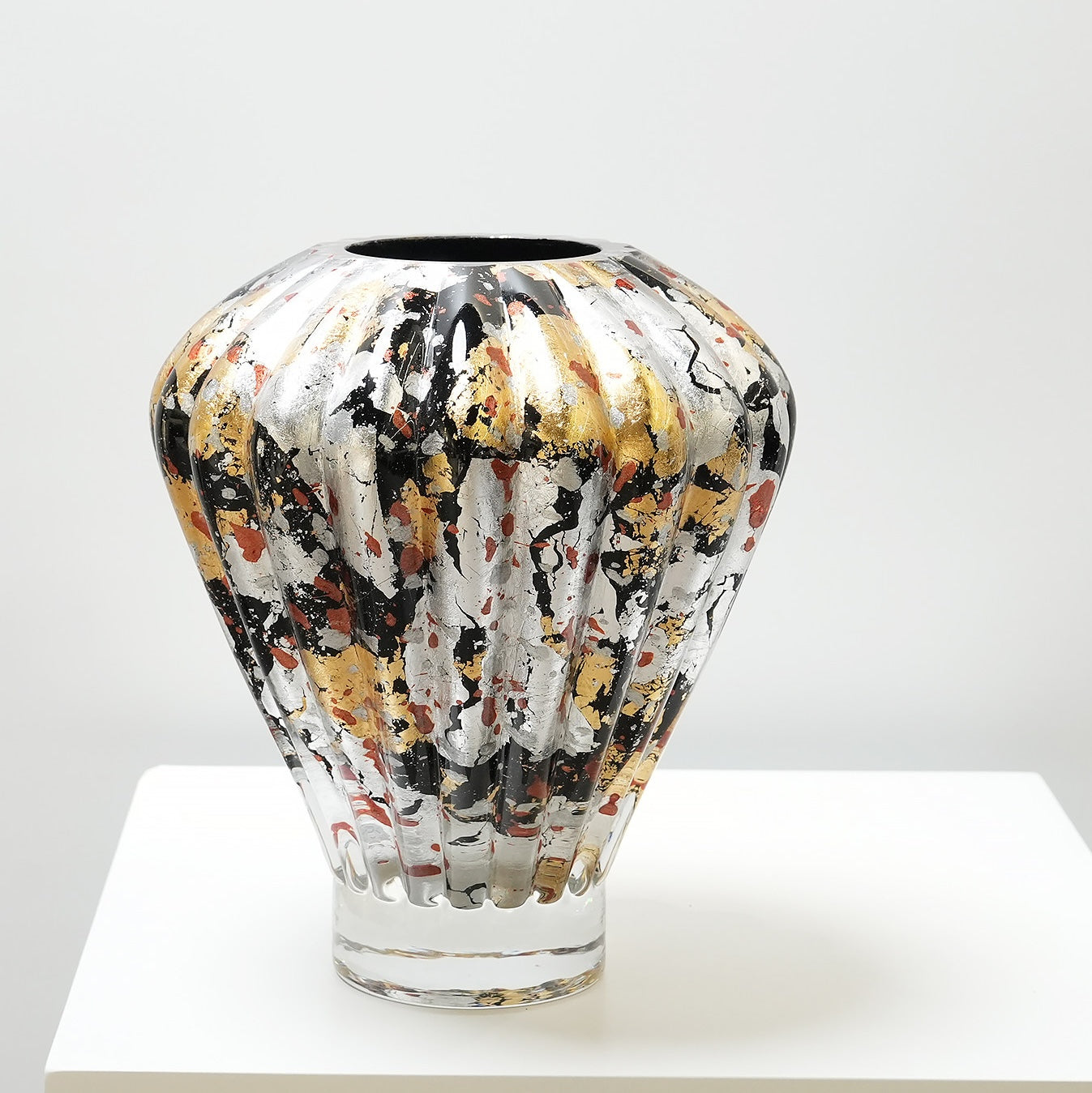 Angled view of the ribbed metallic glass vase