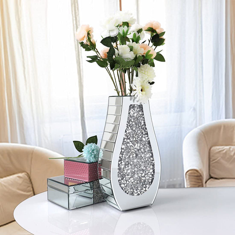 Silver mirrored crushed diamond teardrop vase with flowers on table