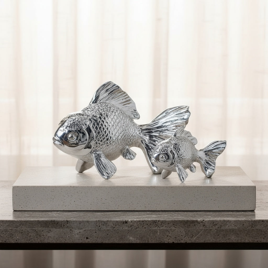 Large and medium silver resin koi fish sculptures on books