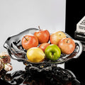 Silver smoked glass fruit bowl filled with apples and pears