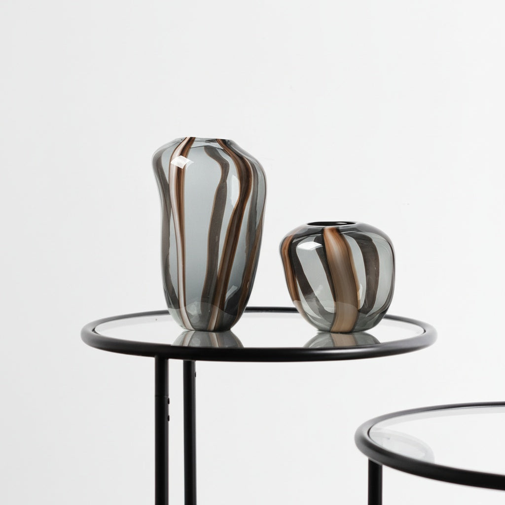 Group shot of large and medium smoke grey and amber striped glass vases on table