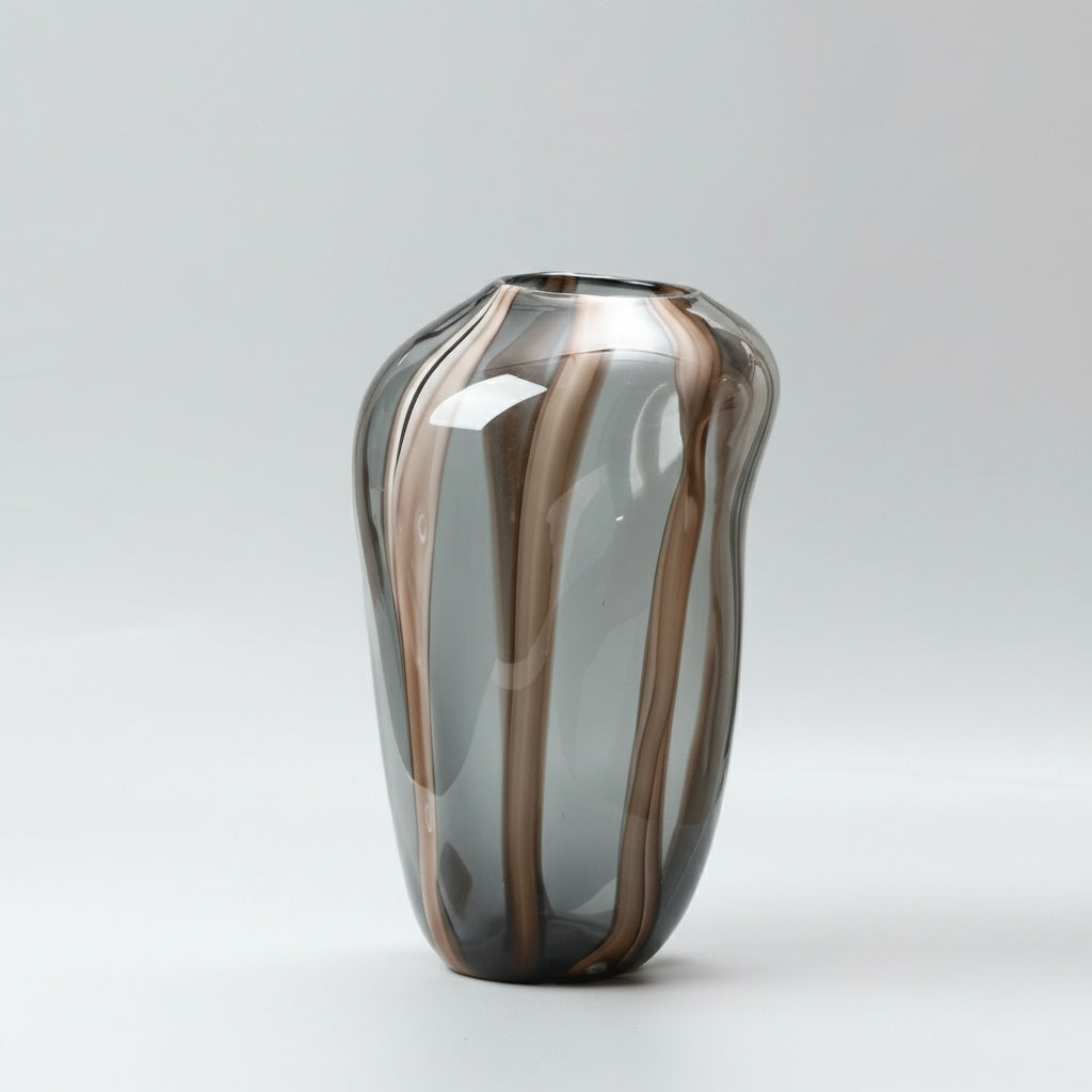 Close up of large smoke grey organic glass vase with amber stripes