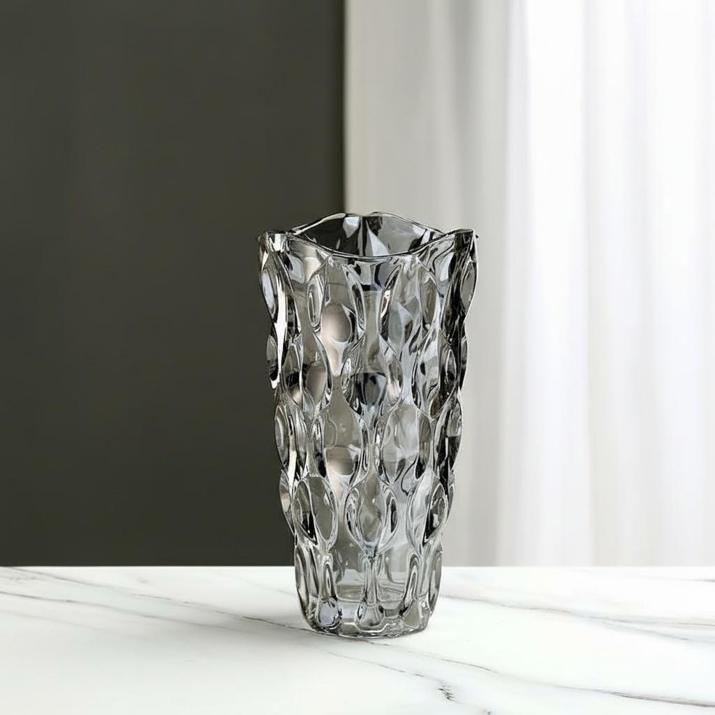 Medium faceted grey glass vase on marble table