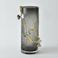 Smoked glass cylindrical vase with gold metal branch and silver butterflies
