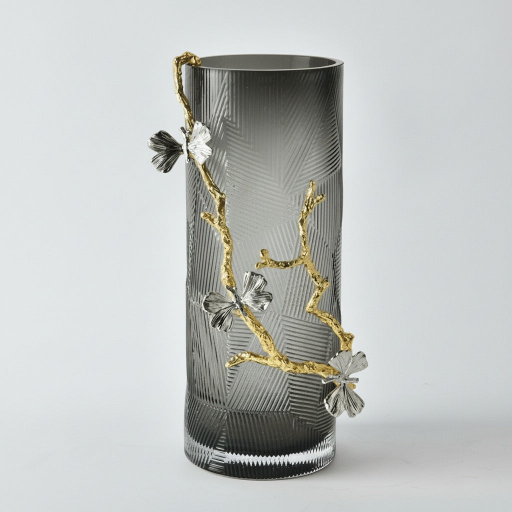 Smoked glass cylindrical vase with gold metal branch and silver butterflies