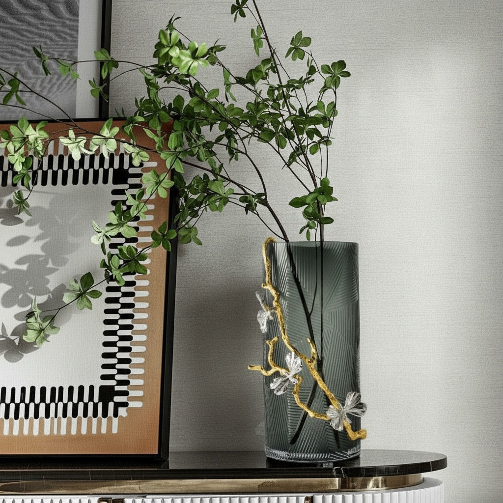 Textured smoked glass vase styled on a dark marble console table with greenery