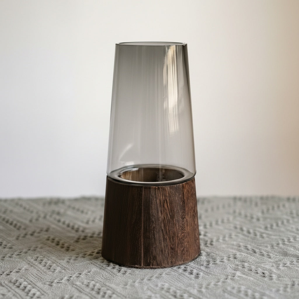 Studio shot of smoked glass and wood vase