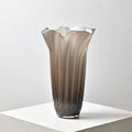 Close up of large smoked grey fluted glass vase with organic ruffled rim