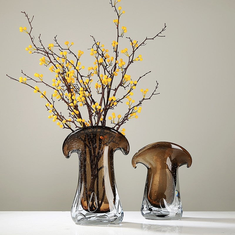 Two amber glass vases with yellow berry branches