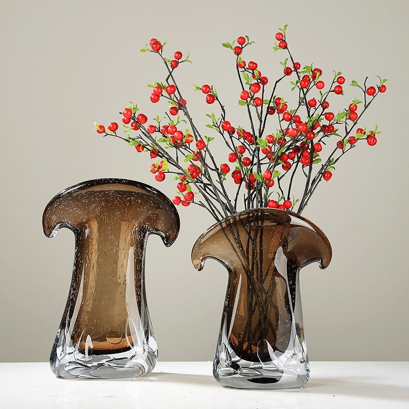Pair of sculptural glass vases with red berry arrangement