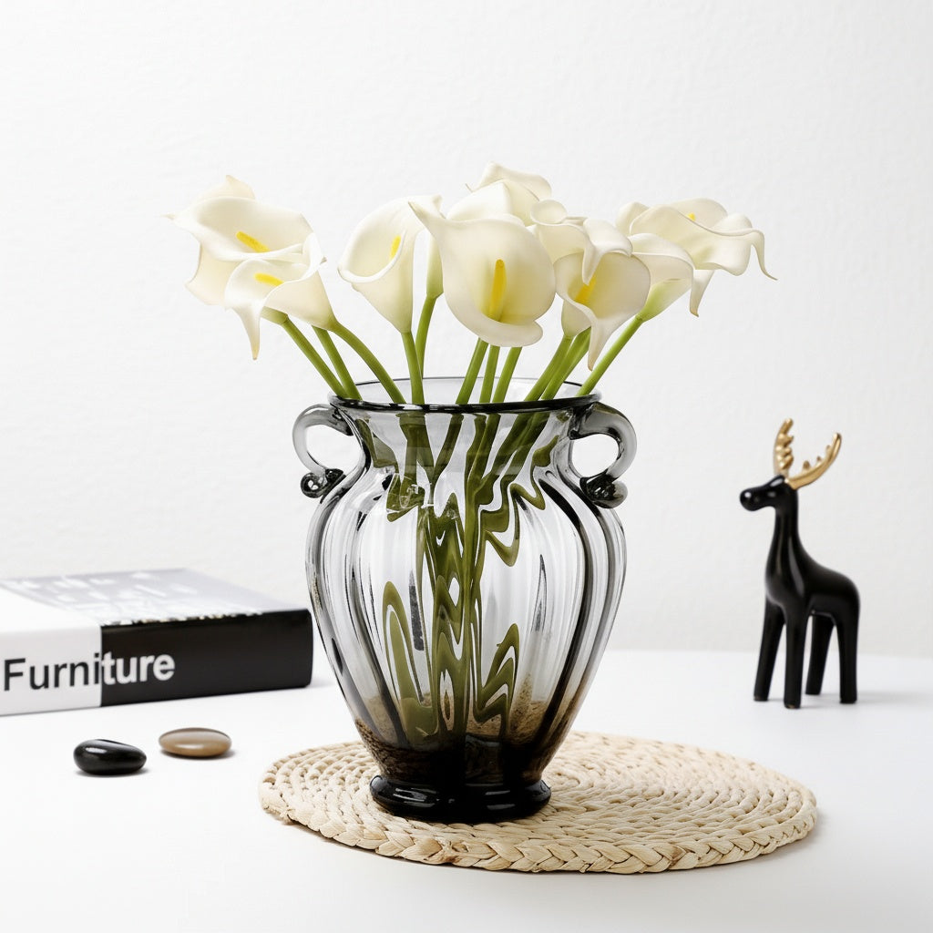 Smoky grey ribbed glass vase with scroll handles and white flowers