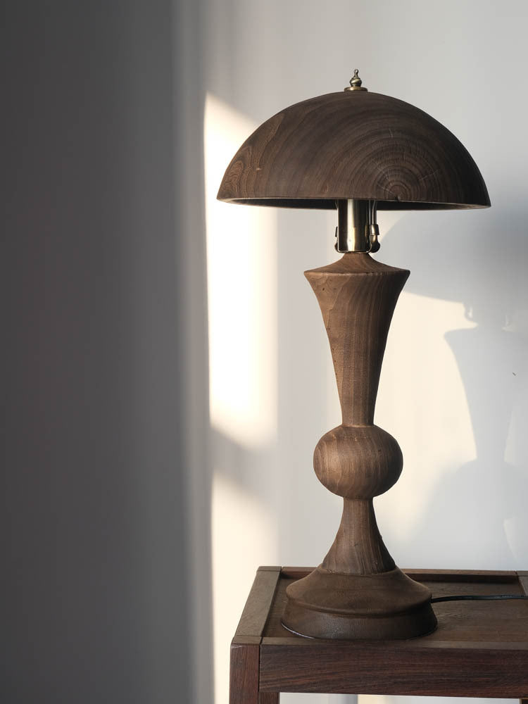 Angled view showing wood grain and brass hardware details