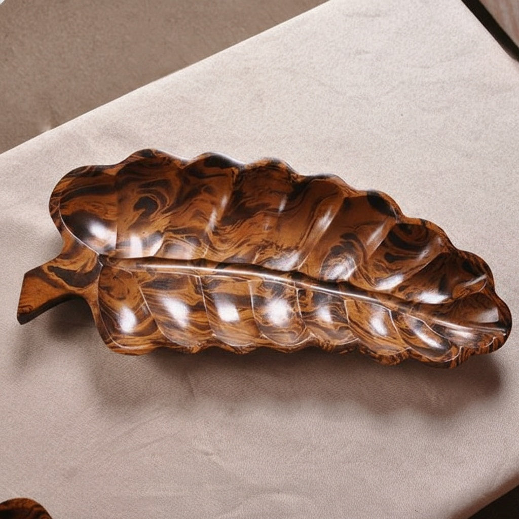 Top view of solid wood leaf shaped serving tray showing rich grain patterns