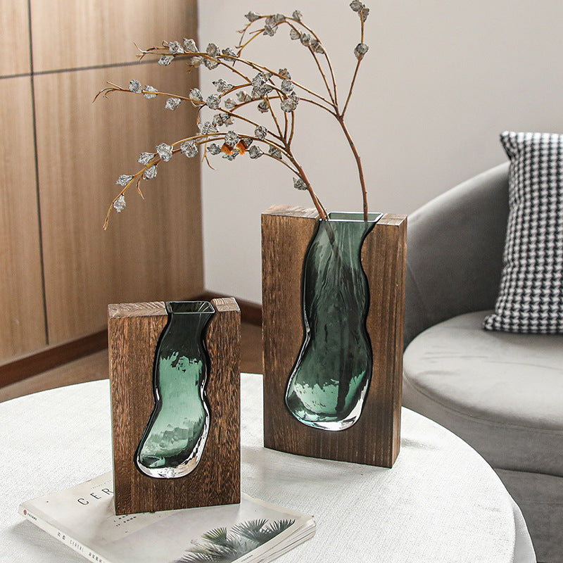 Two solid wood and molten glass vases styled with dried botanicals