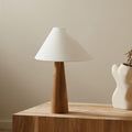 Front view of solid wood tapered base table lamp with white shade