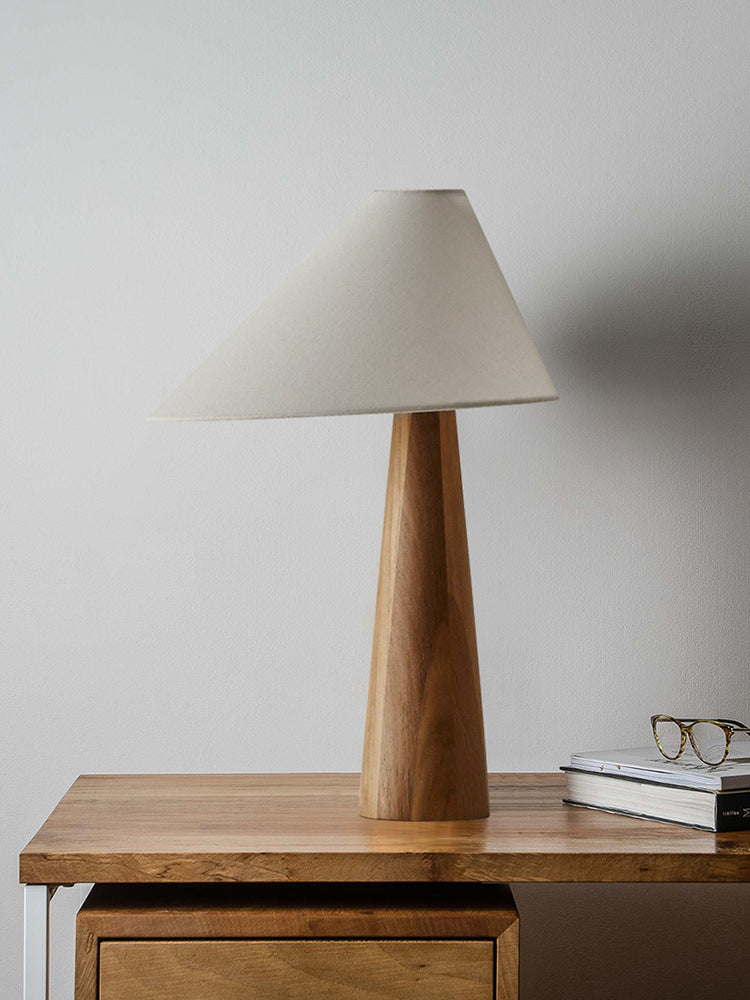 Solid wood table lamp on wooden desk with books