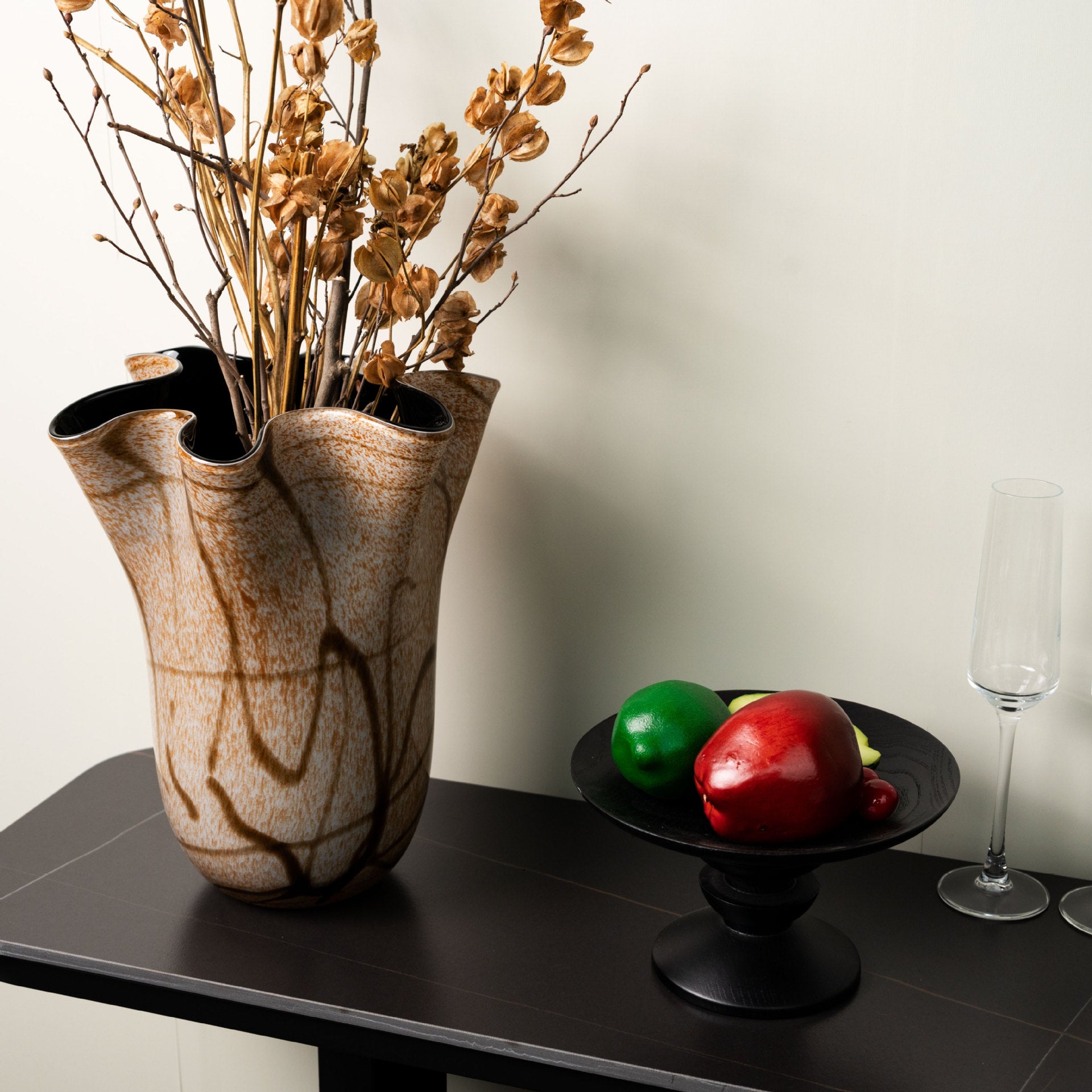 Luxury amber glass vase displayed on console table with fruit bowl