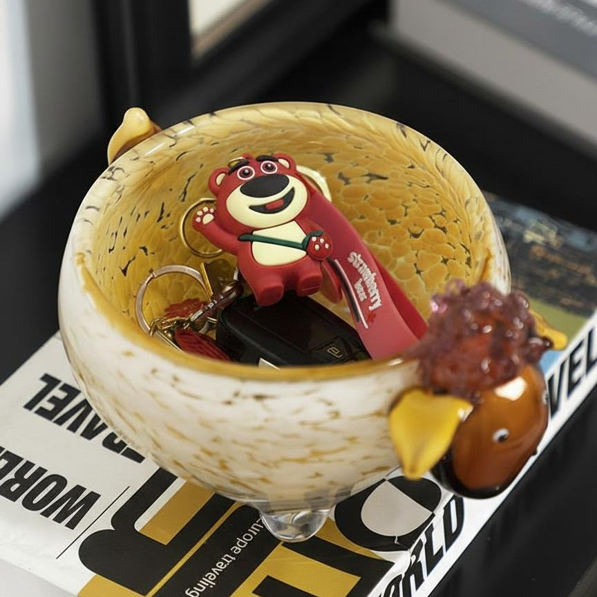 Overhead view of glass sheep bowl holding keys