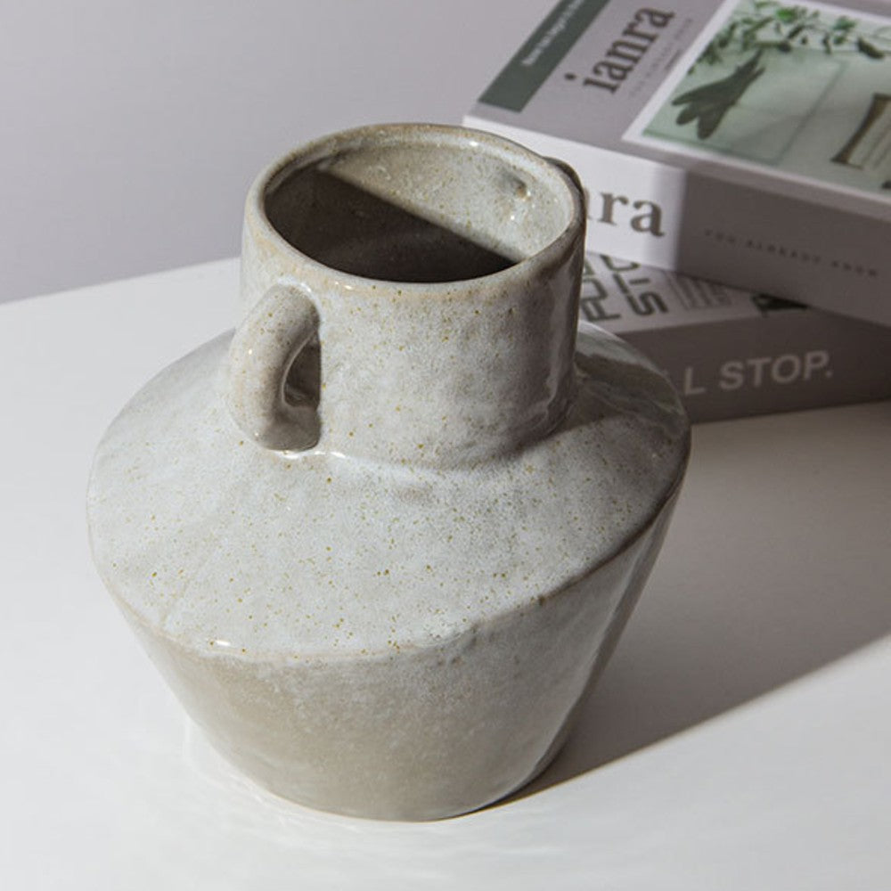 Two handled ceramic vase placed on table modern neutral home decor styling