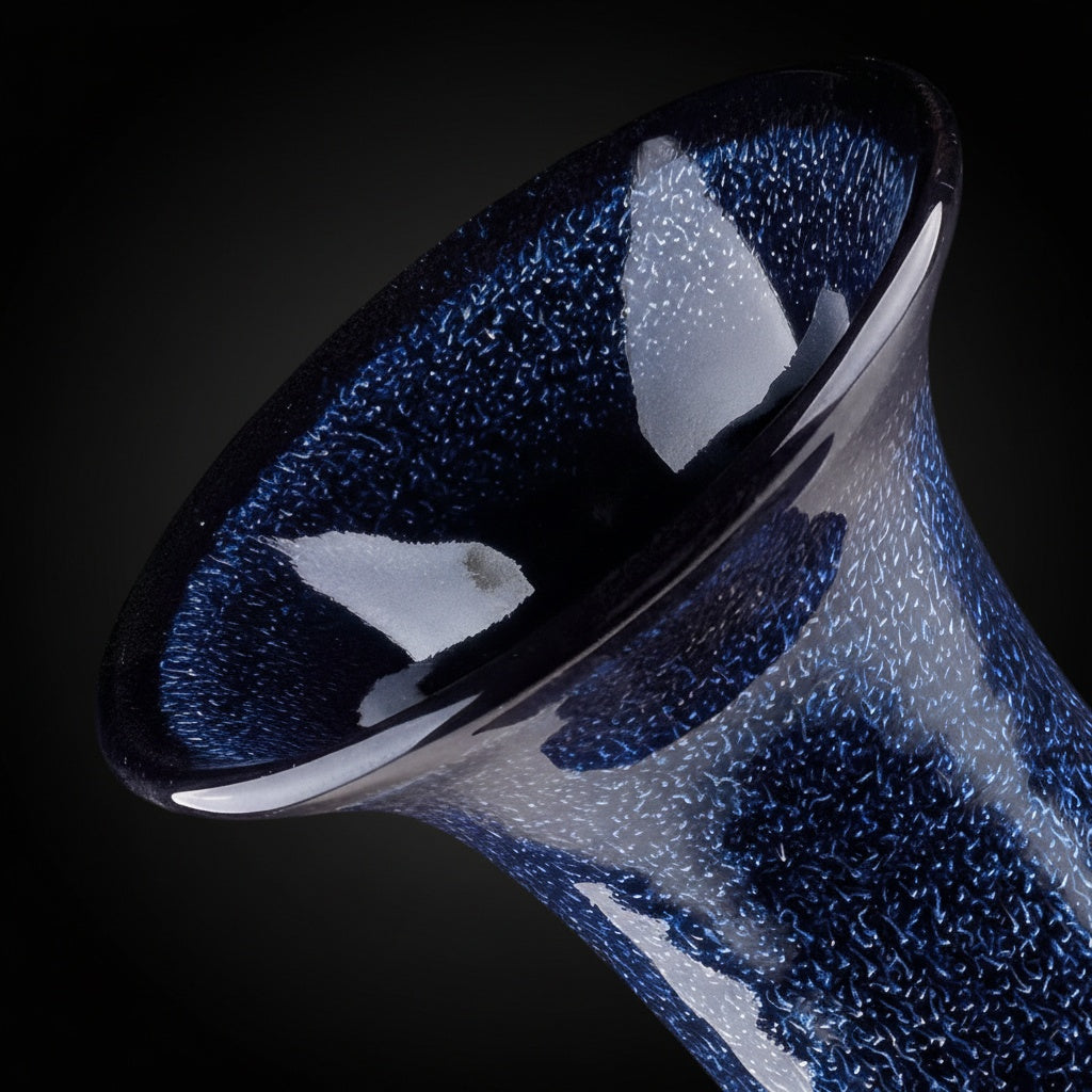 Close up of speckled blue glaze texture on vase rim