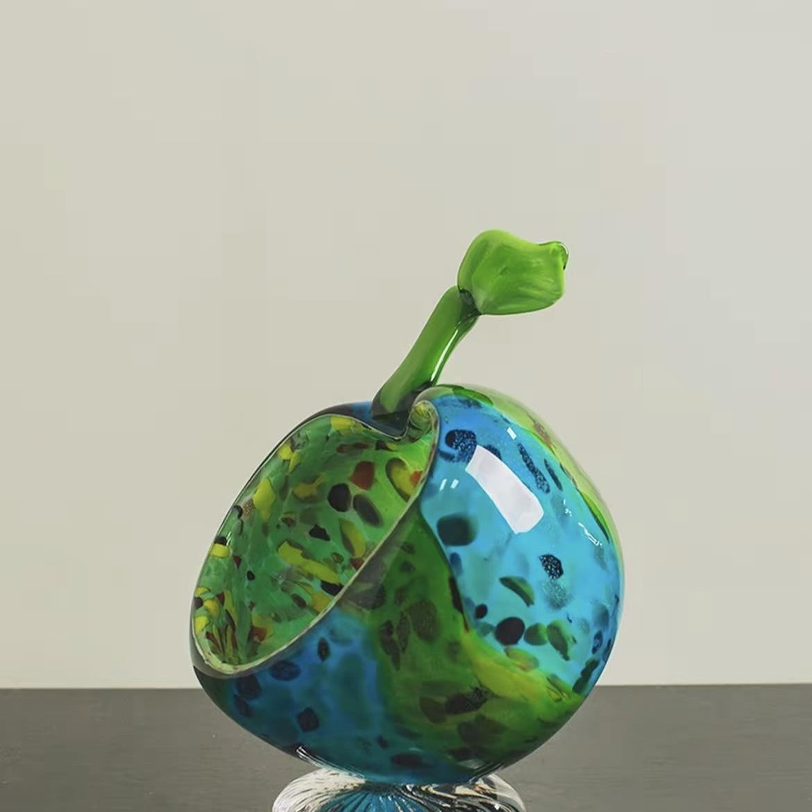 Side view of blue and green glass apple sculpture