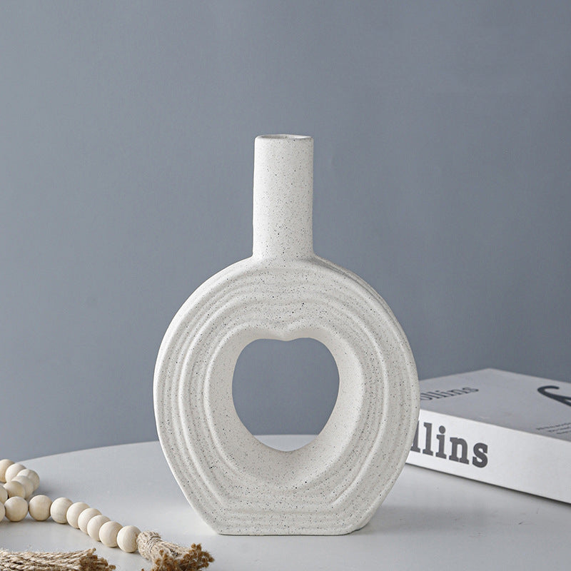 Side profile of hollow ceramic vase showing matte speckled texture