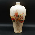 Front view of speckled ceramic vase with relief phoenix motif