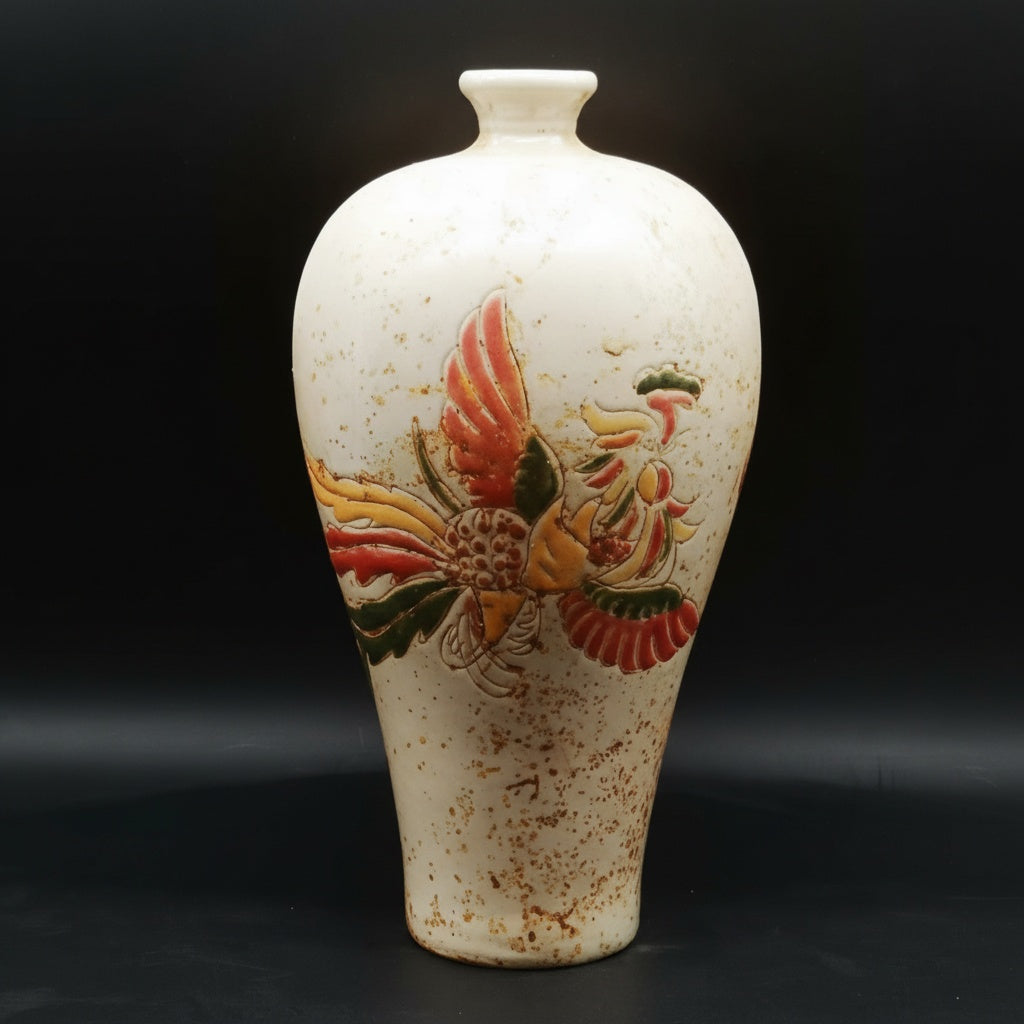 Front view of speckled ceramic vase with relief phoenix motif